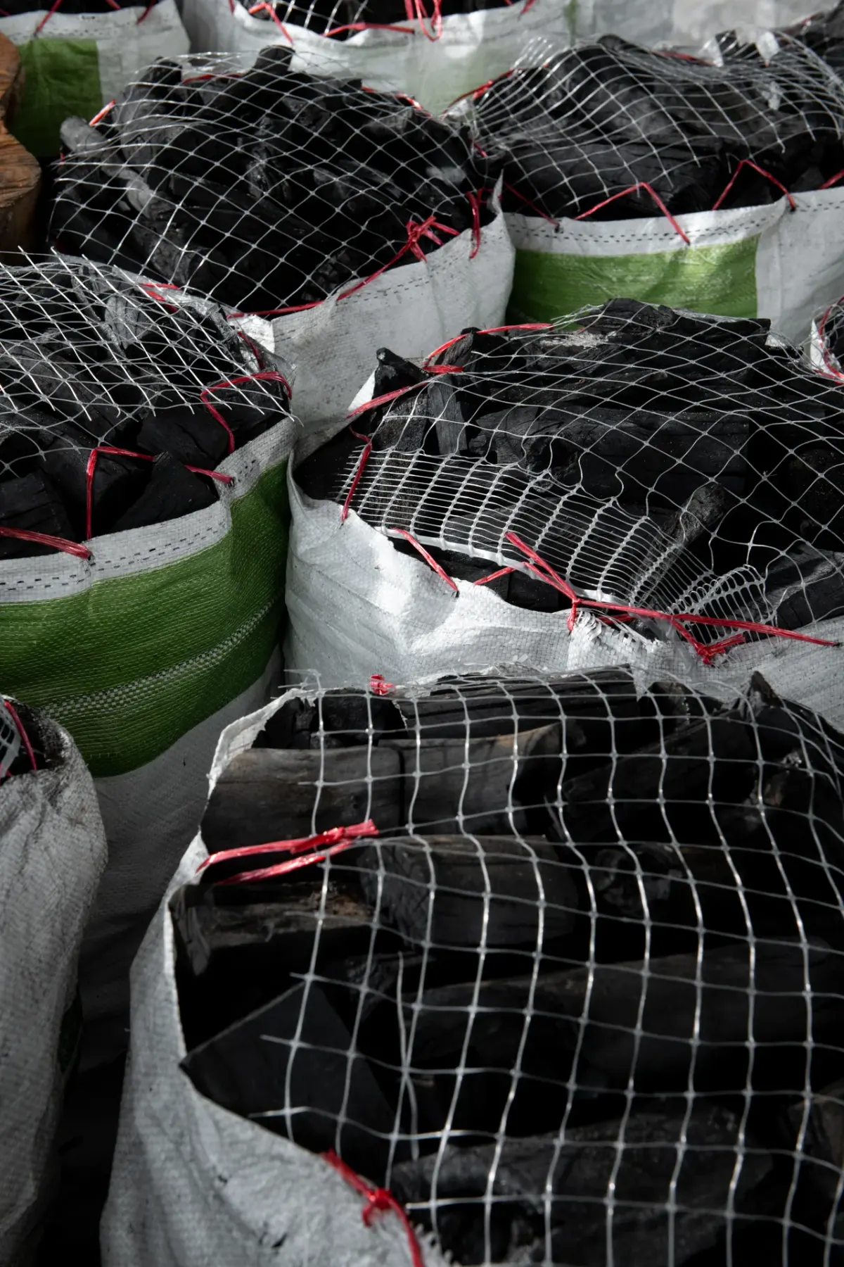 Netted sacks of lump charcoal
