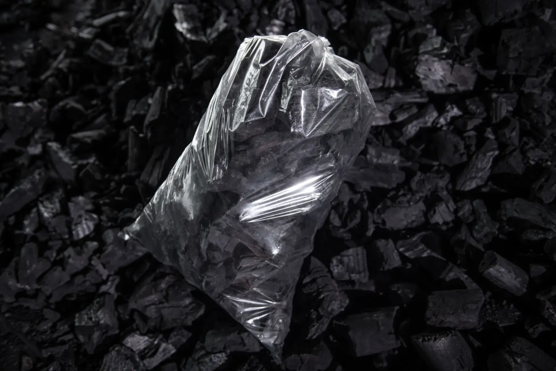 Sealed clear retail bag of BBQ charcoal