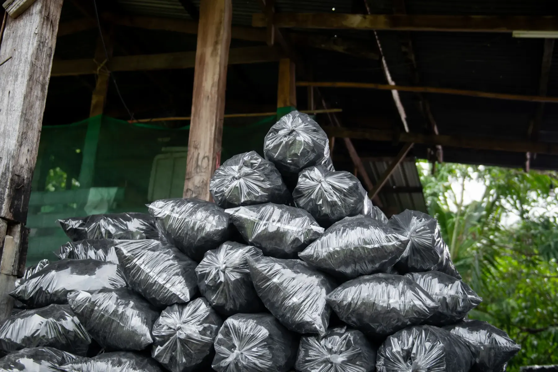 Bagged charcoal in covered storage, ready for export